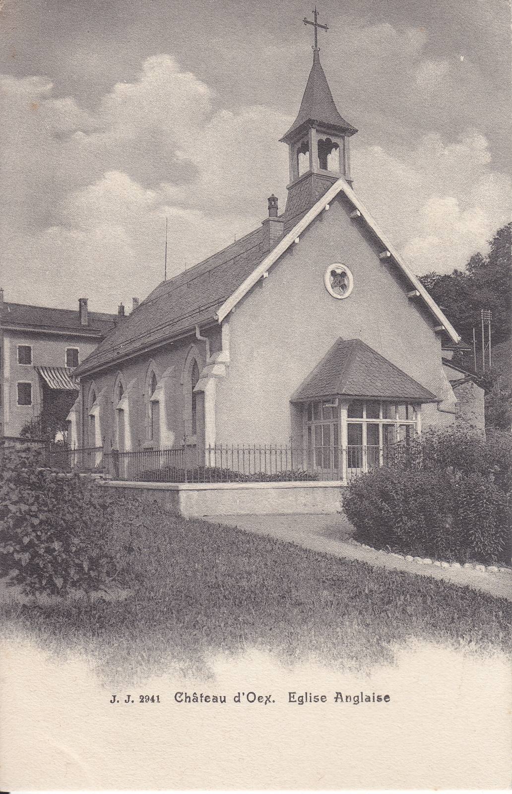 The English church at Château-d'Œx on an old postcard: a small rendered church with a bell turret, a round window in the gable and a glazed porch