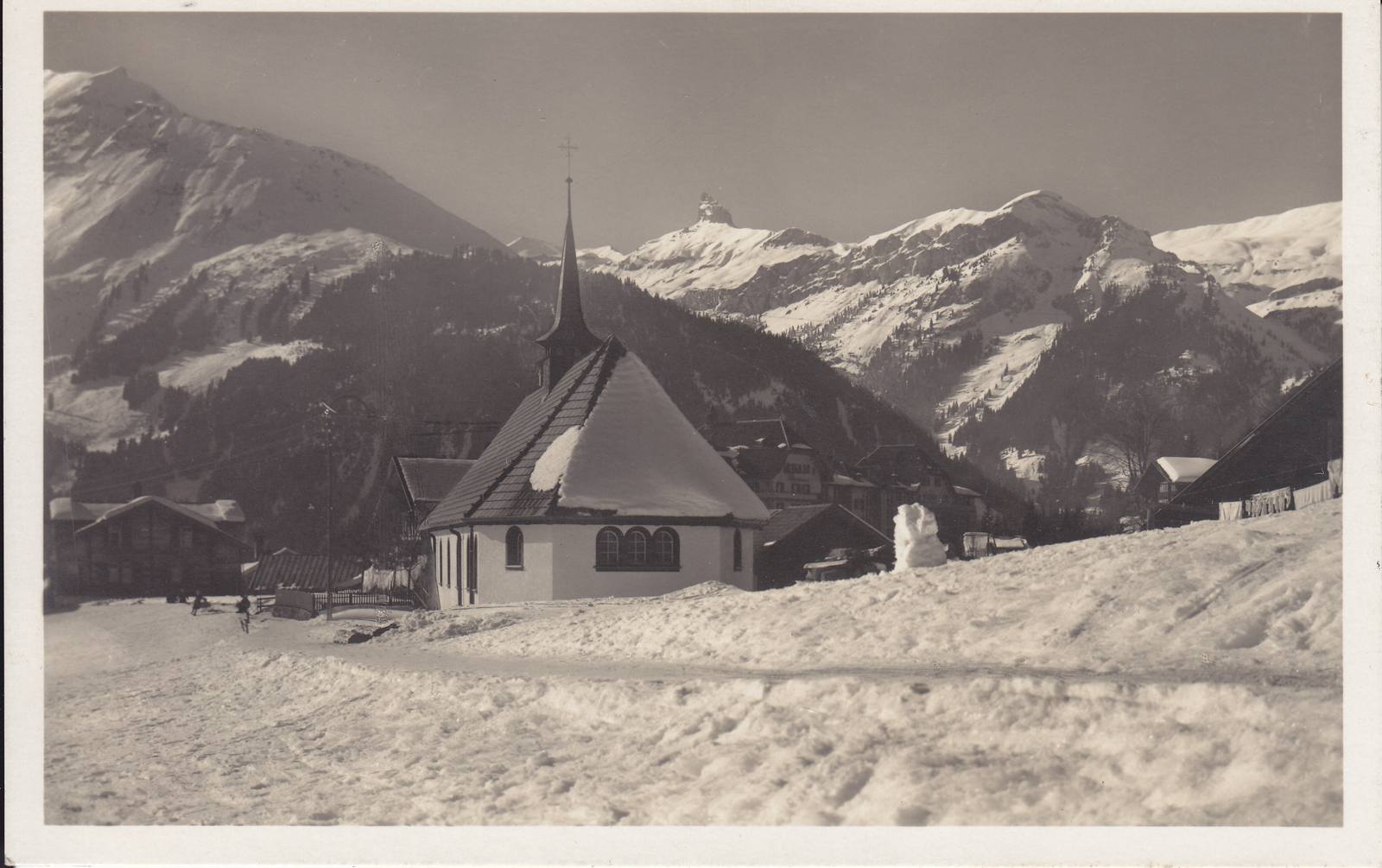St Bernard's, the English church at Wengen, in deep snow, with mountains behind