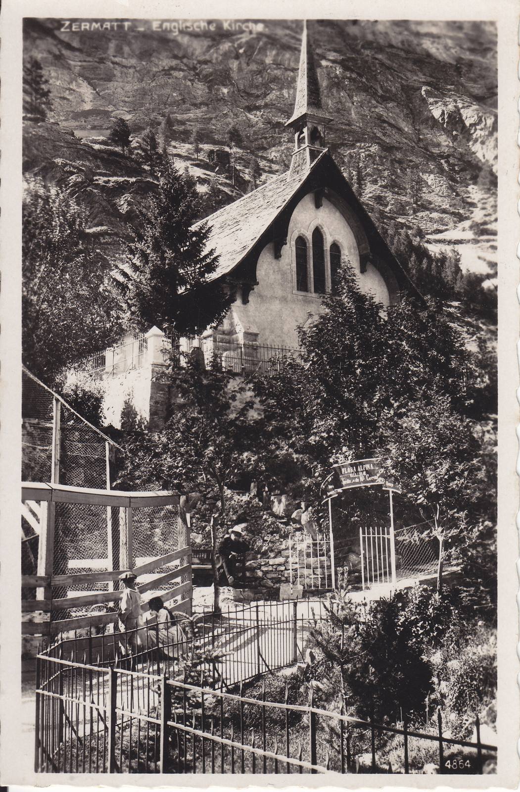 St Peter's, the English church at Zermatt, on an old postcard, with trees and a garden in front